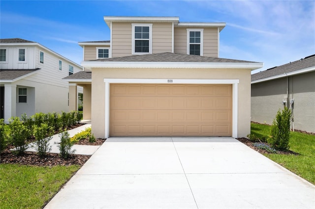808 Lake Dell Rd, Dundee, FL 33838 - view of front of property featuring a shingled roof, driveway, a garage, and stucco siding