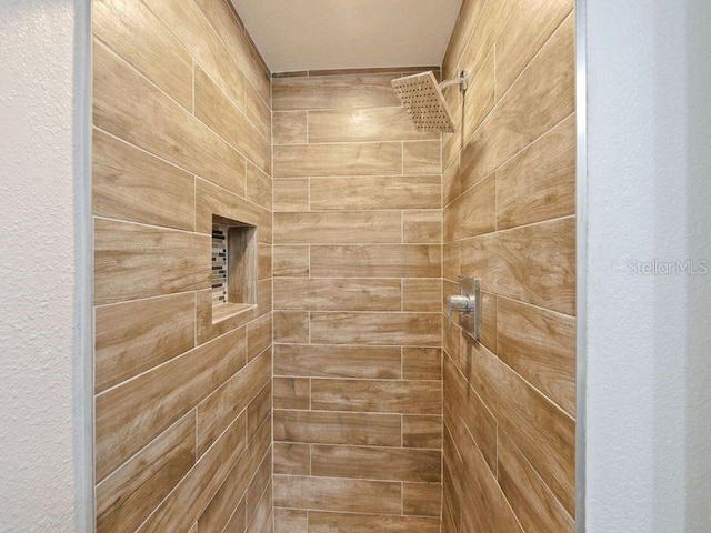 6165 Carrier Dr Unit 1603, Orlando, FL 32819 - bathroom featuring a tile shower