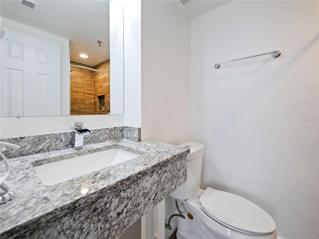 6165 Carrier Dr Unit 1603, Orlando, FL 32819 - bathroom with toilet, a sink, and a shower