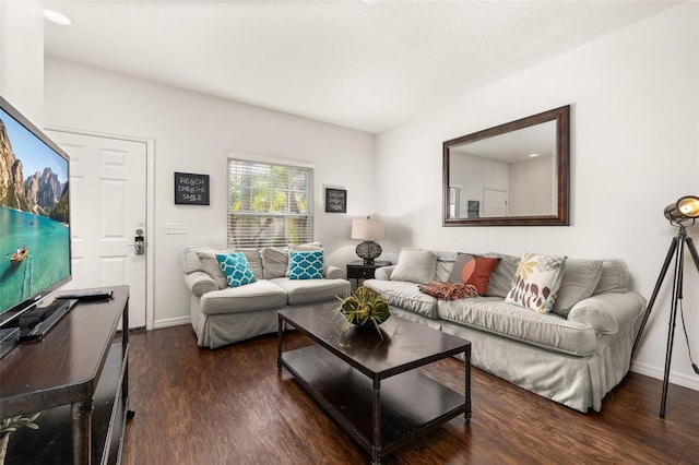 living room featuring dark wood-style flooring and baseboards