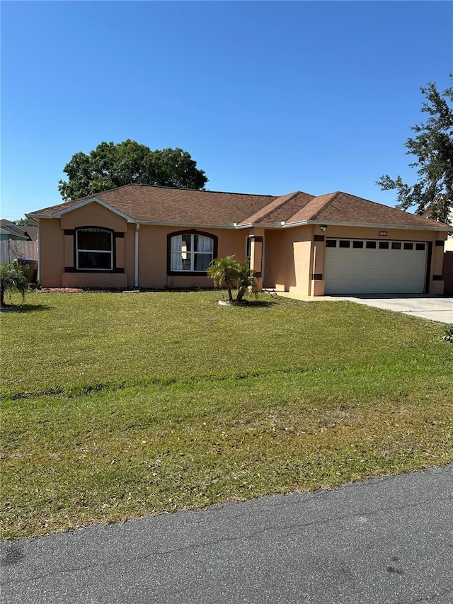 804 Carrousel Ln, Kissimmee, FL 34759 - ranch-style house with stucco siding, driveway, a front yard, and a garage
