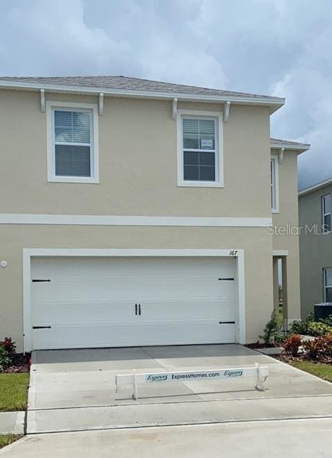 167 Eagleview Loop, Davenport, FL 33837 - traditional-style home with stucco siding, concrete driveway, and a garage