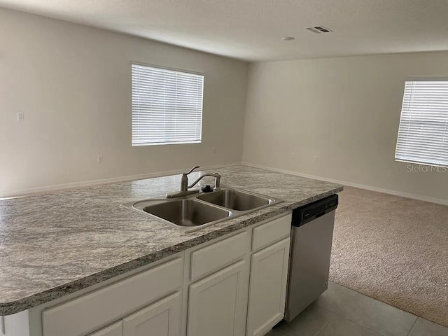 167 Eagleview Loop, Davenport, FL 33837 - kitchen featuring stainless steel dishwasher, a sink, light colored carpet, and white cabinets