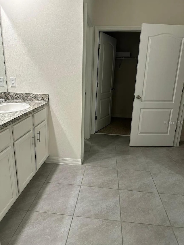 167 Eagleview Loop, Davenport, FL 33837 - bathroom with tile patterned flooring, baseboards, and vanity
