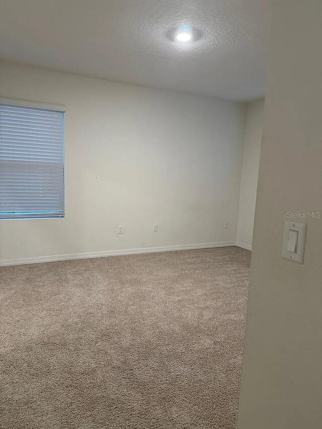 167 Eagleview Loop, Davenport, FL 33837 - carpeted empty room with a textured ceiling, baseboards, and recessed lighting