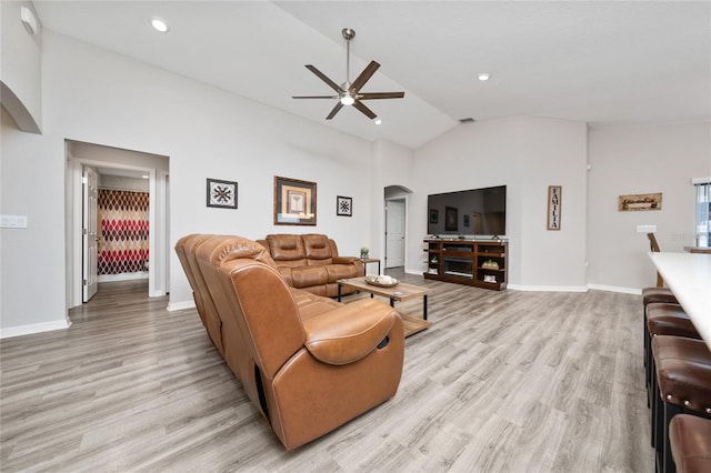2059 Dexter St, Haines City, FL 33844 - living room with light wood finished floors, baseboards, arched walkways, and ceiling fan