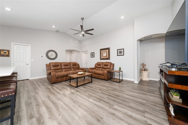 2059 Dexter St, Haines City, FL 33844 - living area with baseboards, arched walkways, a ceiling fan, and light wood-type flooring
