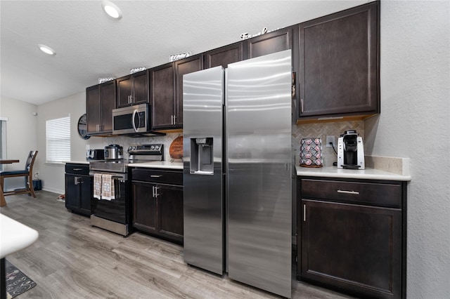 2059 Dexter St, Haines City, FL 33844 - kitchen with decorative backsplash, stainless steel appliances, and light countertops