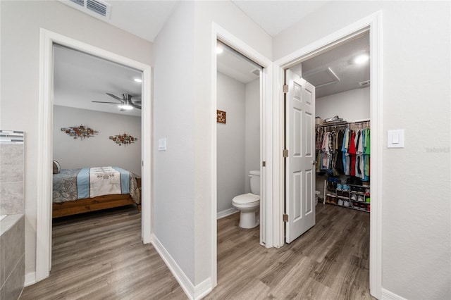 2059 Dexter St, Haines City, FL 33844 - bathroom with toilet, ensuite bathroom, visible vents, wood finished floors, and ceiling fan