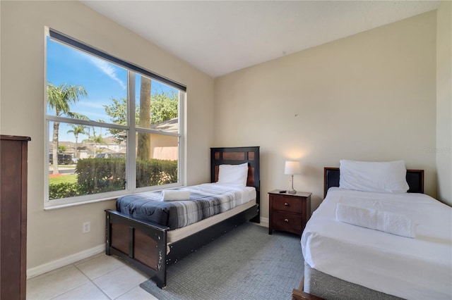 997 Lake Berkley Dr, Kissimmee, FL 34746 - bedroom with baseboards and light tile patterned floors