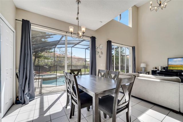 997 Lake Berkley Dr, Kissimmee, FL 34746 - dining room featuring a towering ceiling, an inviting chandelier, and light tile patterned floors