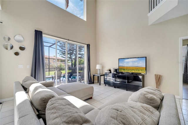 997 Lake Berkley Dr, Kissimmee, FL 34746 - living area featuring baseboards, a high ceiling, and tile patterned flooring
