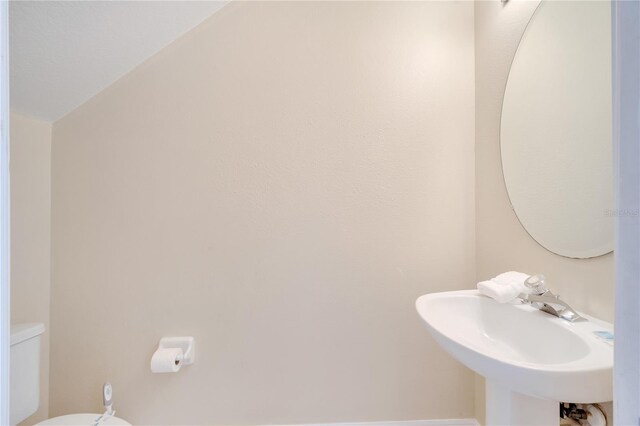 997 Lake Berkley Dr, Kissimmee, FL 34746 - half bathroom featuring toilet and a sink