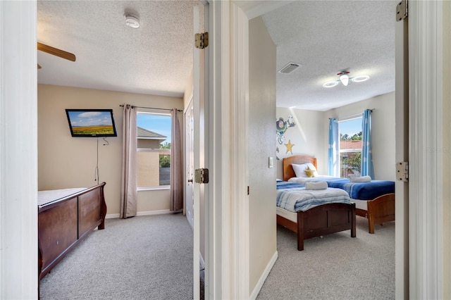 997 Lake Berkley Dr, Kissimmee, FL 34746 - bedroom with a textured ceiling, light carpet, and visible vents