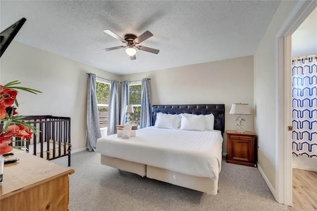 997 Lake Berkley Dr, Kissimmee, FL 34746 - bedroom featuring light colored carpet, baseboards, a ceiling fan, and a textured ceiling