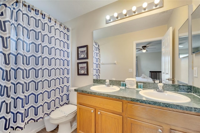 997 Lake Berkley Dr, Kissimmee, FL 34746 - bathroom featuring ceiling fan, toilet, a sink, and double vanity