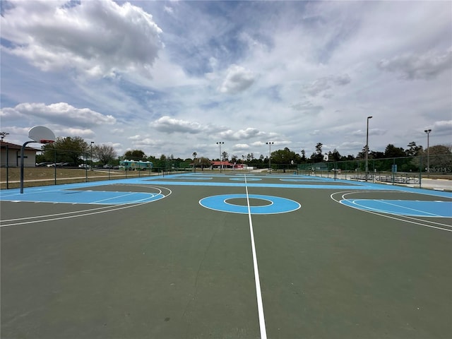 view of basketball court featuring fence and community basketball court