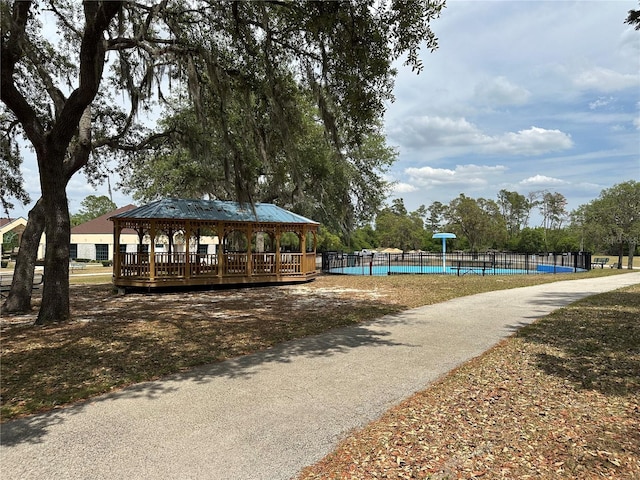 view of home's community featuring a gazebo, fence, and a swimming pool