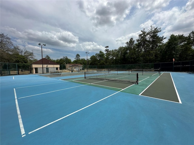 view of tennis court featuring fence