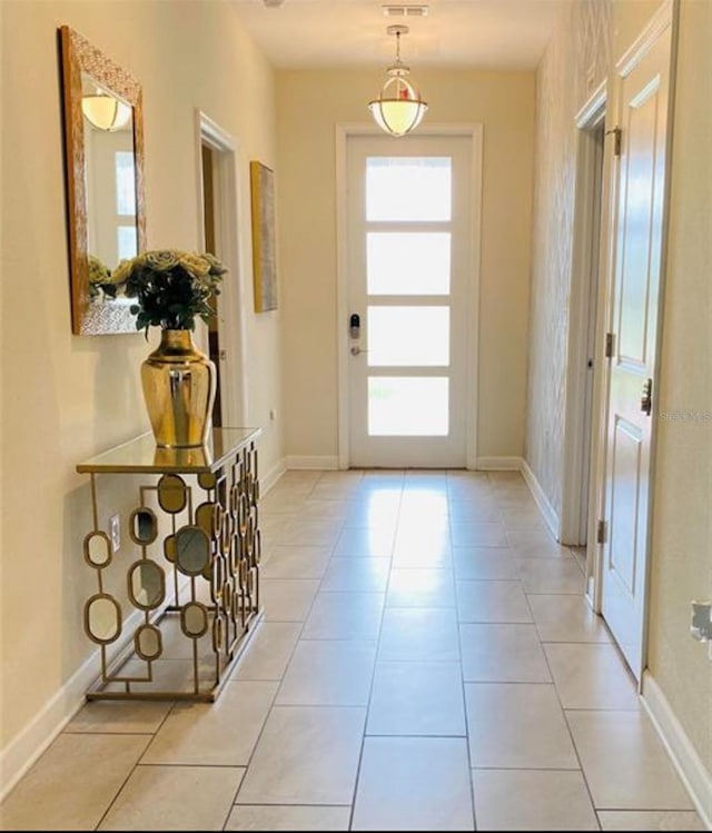 345 Ocean Course Ave, Davenport, FL 33896 - doorway featuring baseboards and light tile patterned flooring