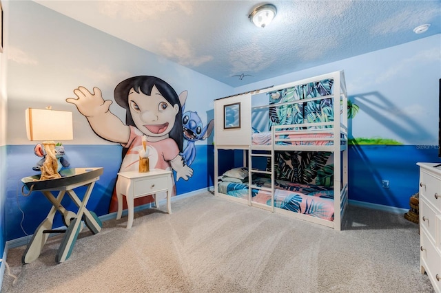 carpeted bedroom featuring baseboards and a textured ceiling