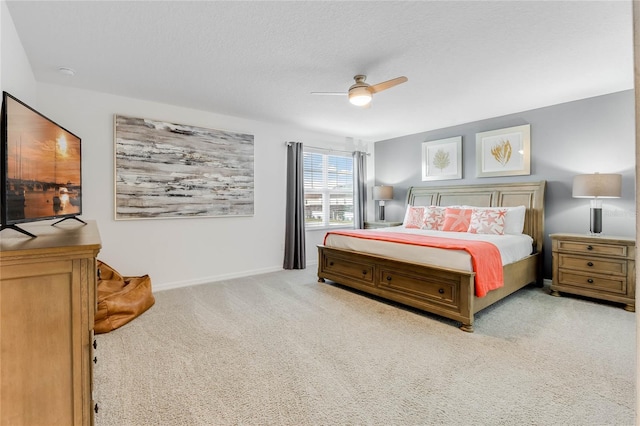 bedroom featuring ceiling fan, baseboards, and carpet