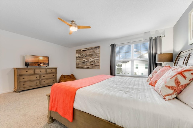 bedroom featuring ceiling fan and light carpet