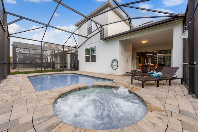 outdoor pool with a lanai, a patio, and an in ground hot tub