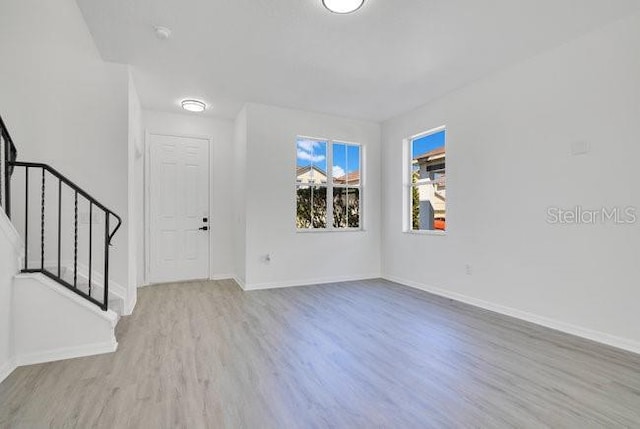 227 Sand Ridge Dr, Davenport, FL 33896 - interior space with baseboards, wood finished floors, and stairs