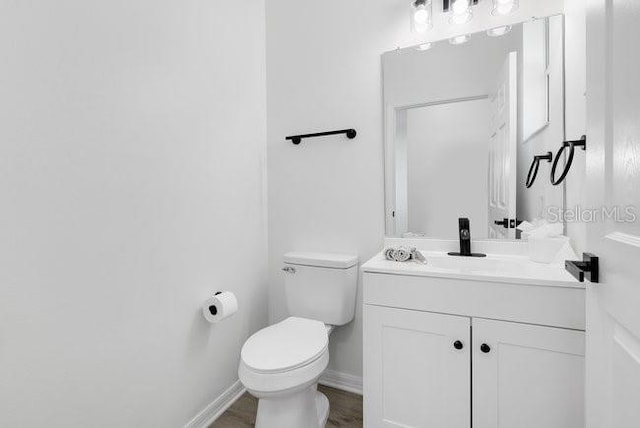 227 Sand Ridge Dr, Davenport, FL 33896 - bathroom with baseboards, vanity, and toilet