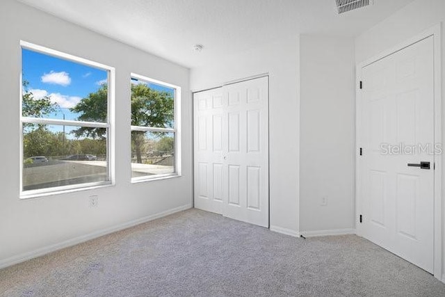 227 Sand Ridge Dr, Davenport, FL 33896 - unfurnished bedroom with baseboards, visible vents, carpet floors, and a closet