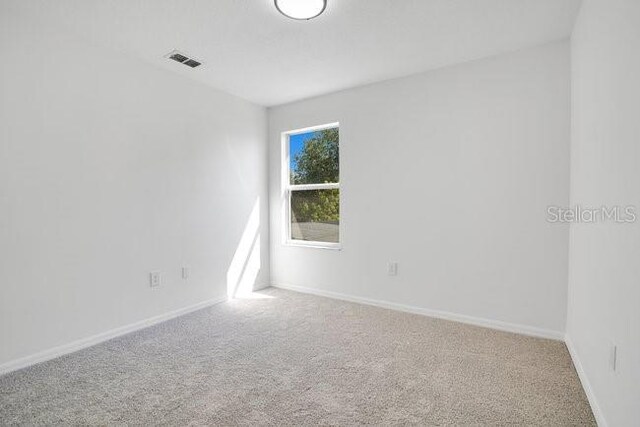 227 Sand Ridge Dr, Davenport, FL 33896 - carpeted empty room featuring baseboards and visible vents