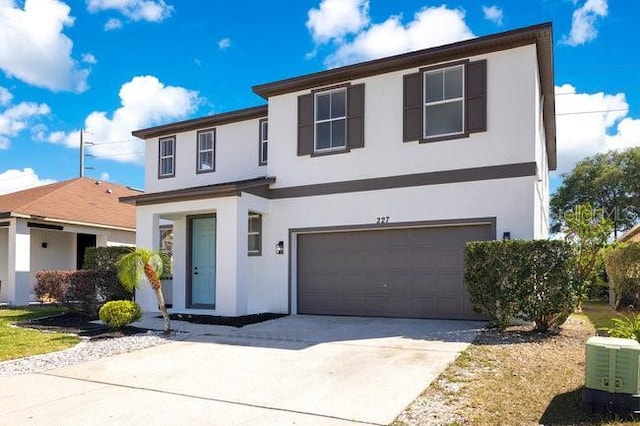 227 Sand Ridge Dr, Davenport, FL 33896 - traditional home featuring stucco siding, central AC unit, concrete driveway, and a garage