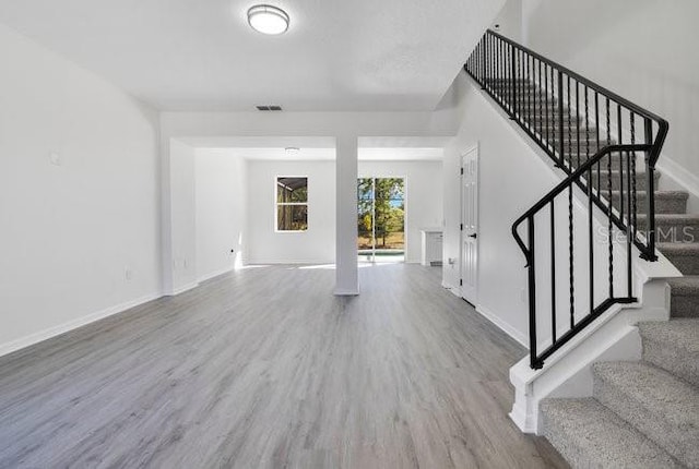 227 Sand Ridge Dr, Davenport, FL 33896 - interior space featuring baseboards, wood finished floors, visible vents, and stairs