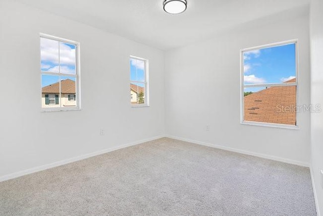227 Sand Ridge Dr, Davenport, FL 33896 - carpeted spare room with baseboards