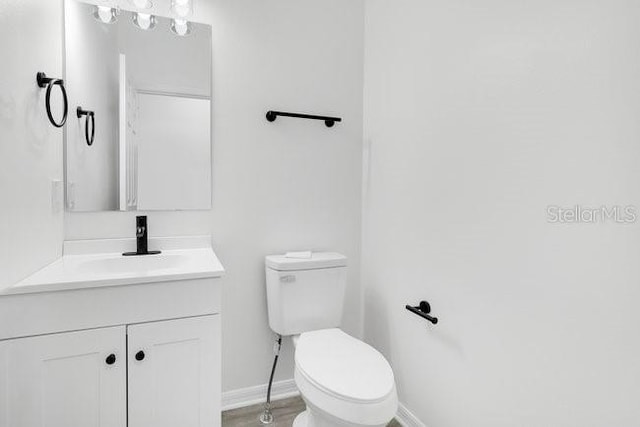 227 Sand Ridge Dr, Davenport, FL 33896 - bathroom featuring baseboards, toilet, and vanity