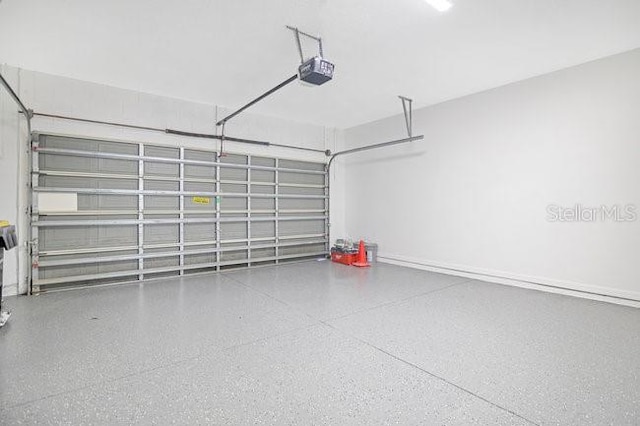 227 Sand Ridge Dr, Davenport, FL 33896 - garage featuring a garage door opener