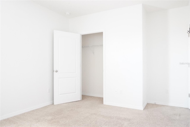 9016 Pyrus St, Kissimmee, FL 34747 - unfurnished bedroom featuring light colored carpet, a closet, and baseboards