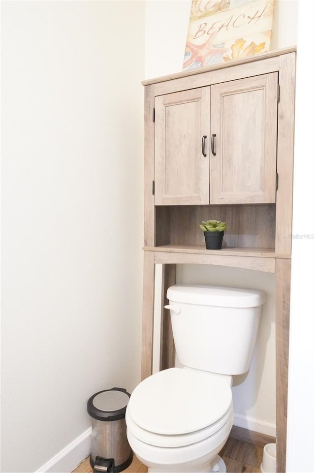9016 Pyrus St, Kissimmee, FL 34747 - bathroom with baseboards, toilet, and wood finished floors