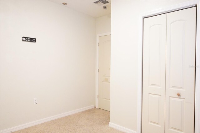 9016 Pyrus St, Kissimmee, FL 34747 - unfurnished bedroom with light carpet, baseboards, and a closet