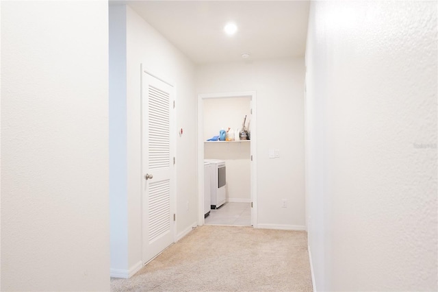 9016 Pyrus St, Kissimmee, FL 34747 - hall featuring washer and dryer, light colored carpet, and baseboards