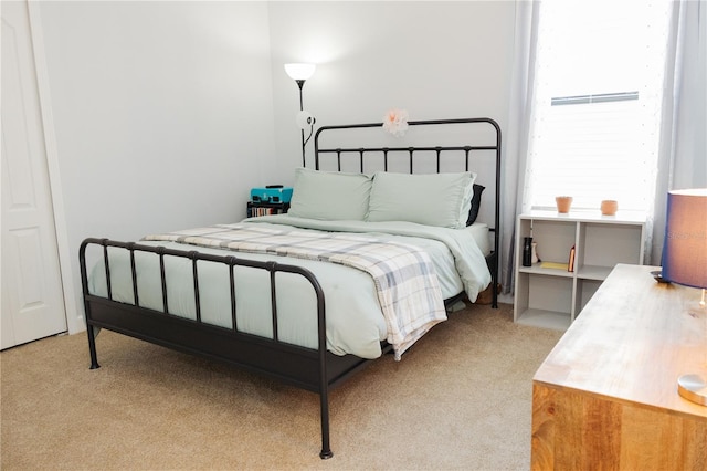 bedroom featuring light carpet