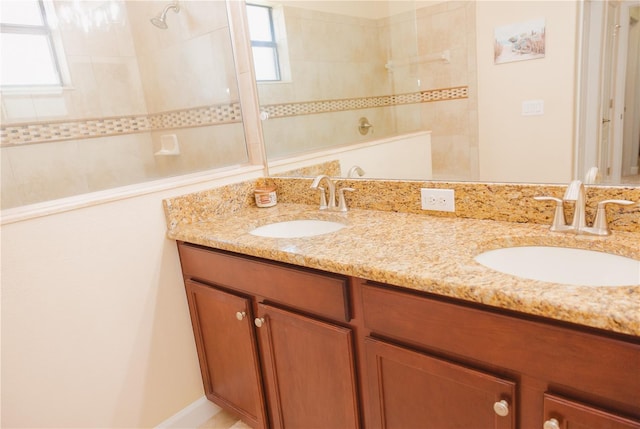 full bath featuring a sink, a walk in shower, and plenty of natural light