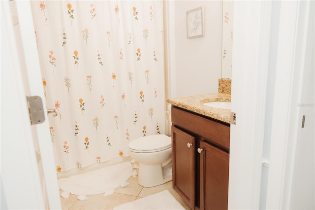 bathroom featuring vanity, tile patterned flooring, toilet, and curtained shower