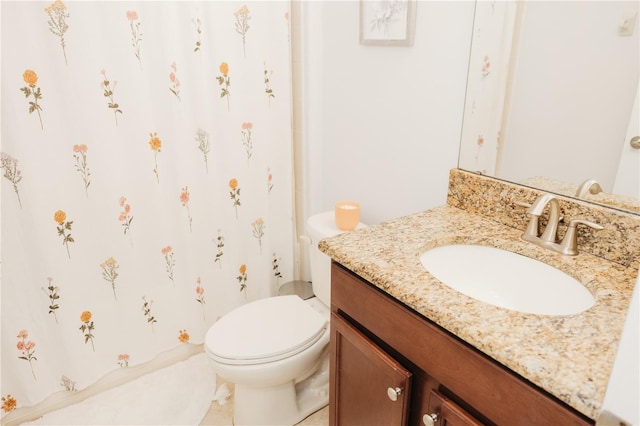 bathroom featuring toilet and vanity