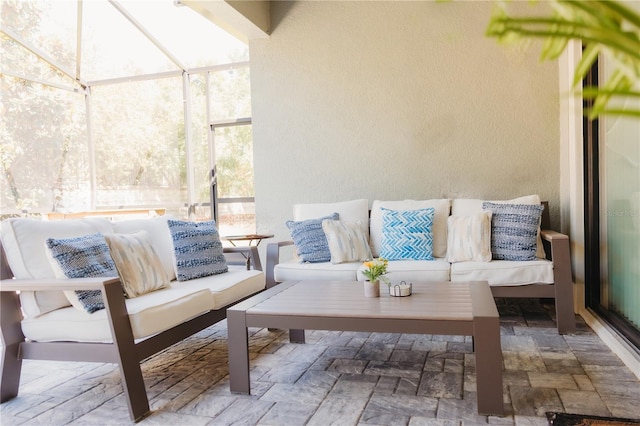 view of patio with glass enclosure and an outdoor hangout area