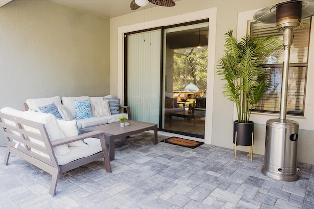 view of patio / terrace with ceiling fan and an outdoor living space