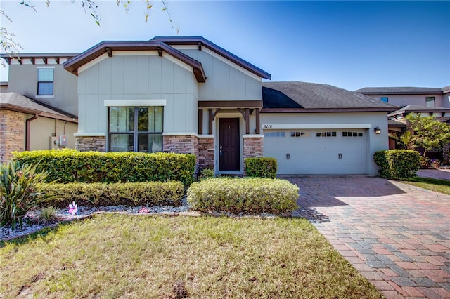 5118 Tiber Way, Saint Cloud, FL 34771 - craftsman-style home with a front lawn, decorative driveway, and a garage
