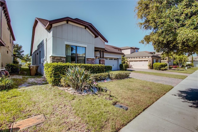 5118 Tiber Way, Saint Cloud, FL 34771 - view of front of home featuring an attached garage, driveway, stone siding, and a front yard
