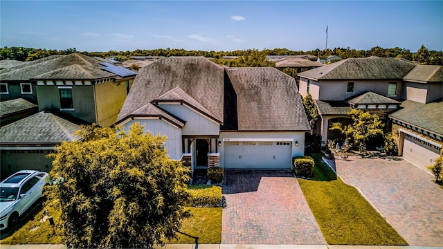 5118 Tiber Way, Saint Cloud, FL 34771 - view of front of home with an attached garage, stucco siding, a residential view, and decorative driveway